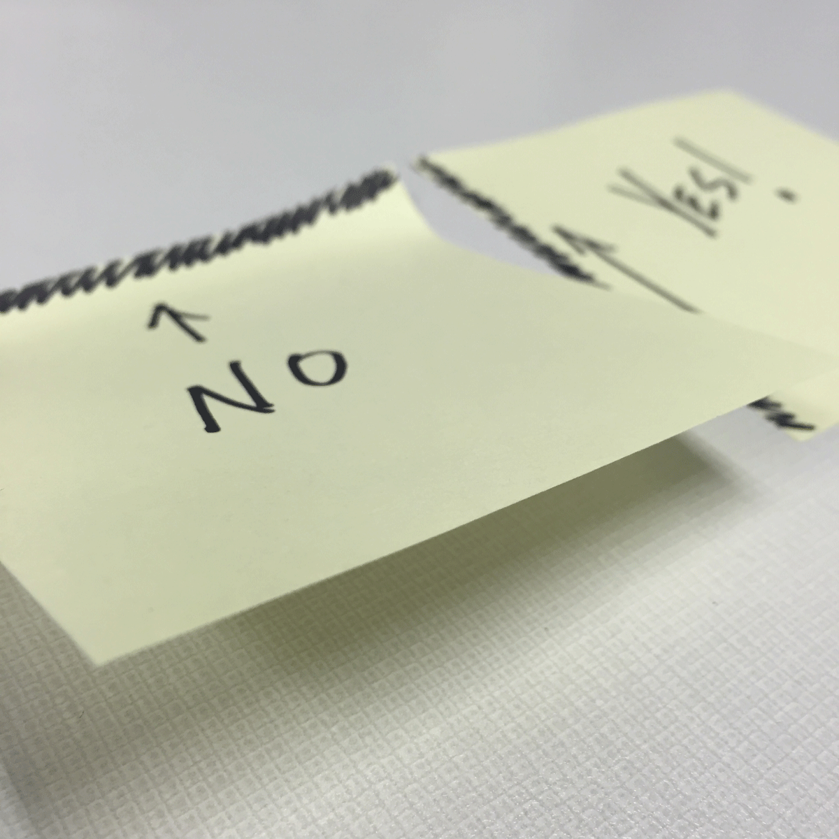 The wrong way to peel post-it notes and the right way side by side